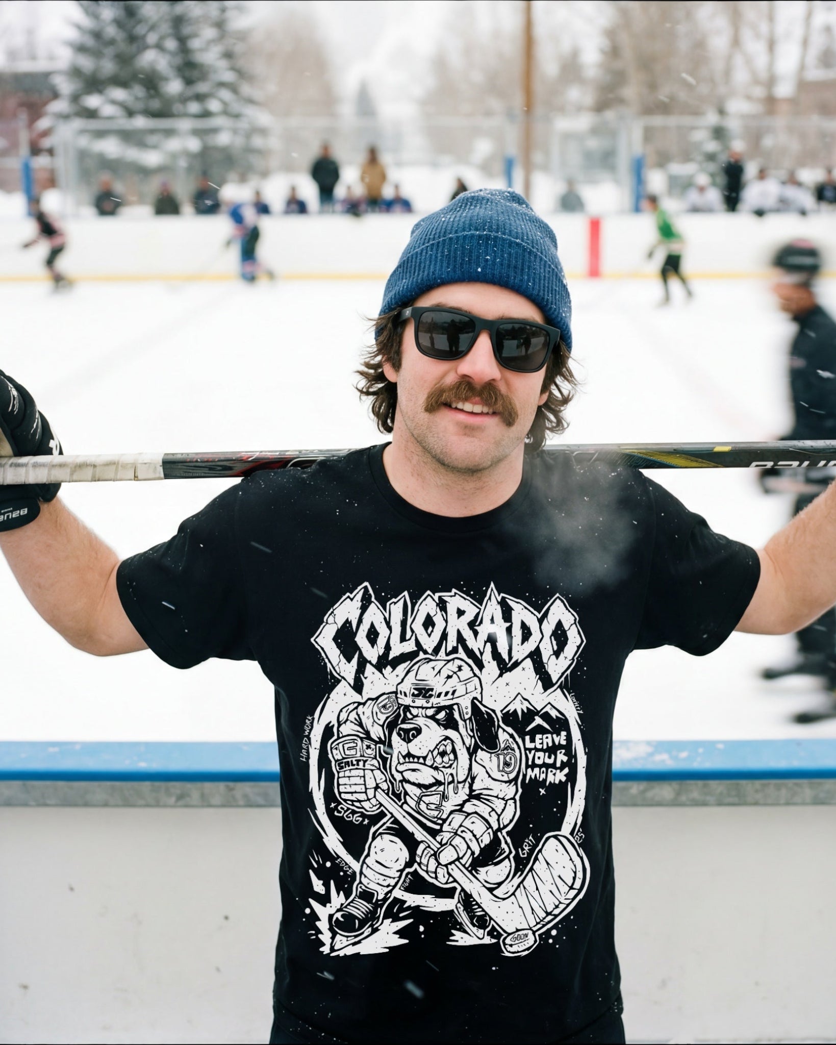 man wearing Colorado Ice hockey tee shirt from salty goon gear. black shirt, with aggressive awesome gritty dog hockey player on front 