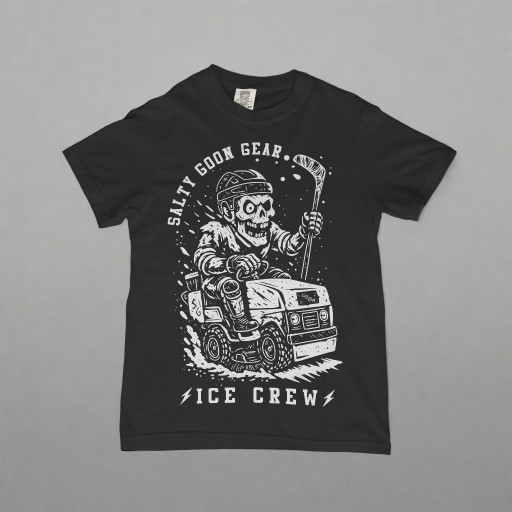 Black t-shirt with a graphic design of a skeleton driving a vehicle and text 'Salty Goon Gear Ice Crew' on a concrete surface.