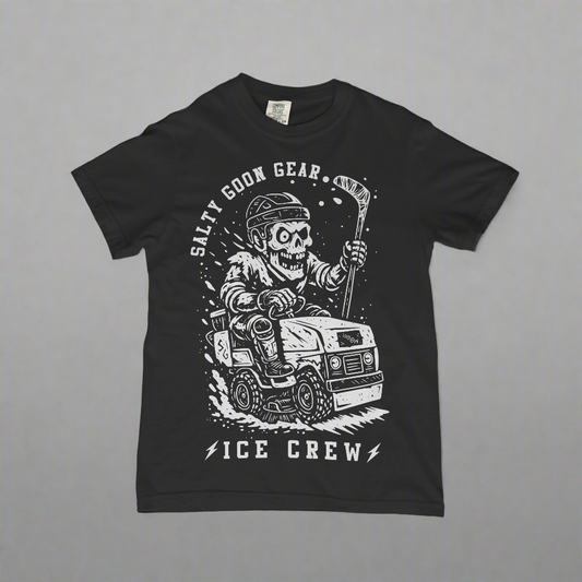 Black t-shirt with a graphic design of a skeleton driving a vehicle and text 'Salty Goon Gear Ice Crew' on a concrete surface.