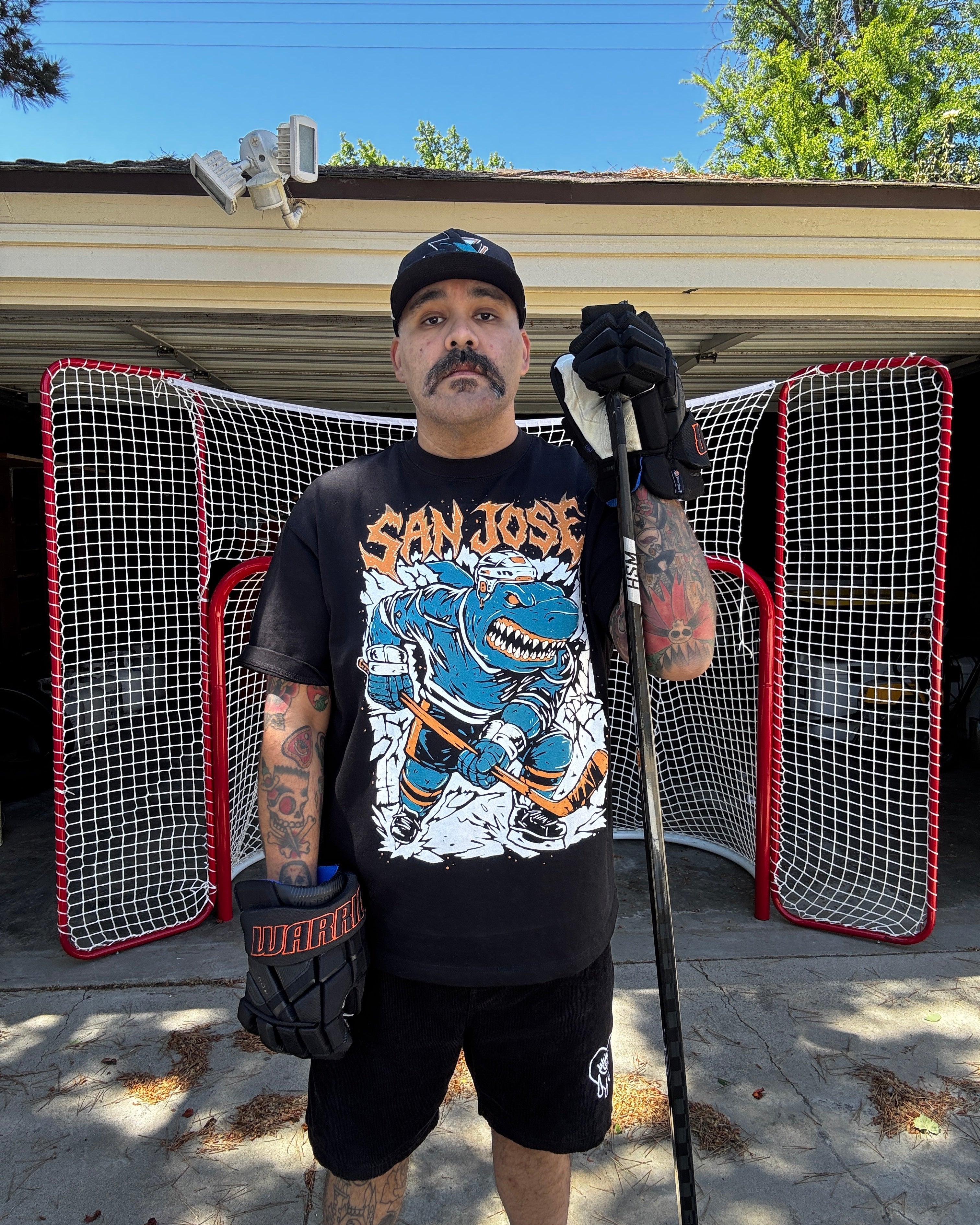 Millennial Man wearing San Jose Ice Hockey shirt, of an aggressive street shark hockey player enforcer 
