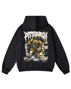 A black pullover hoodie shown from the back, featuring a large graphic print of a hockey player in yellow and black with the word 'Pittsburgh' in a distressed white font.