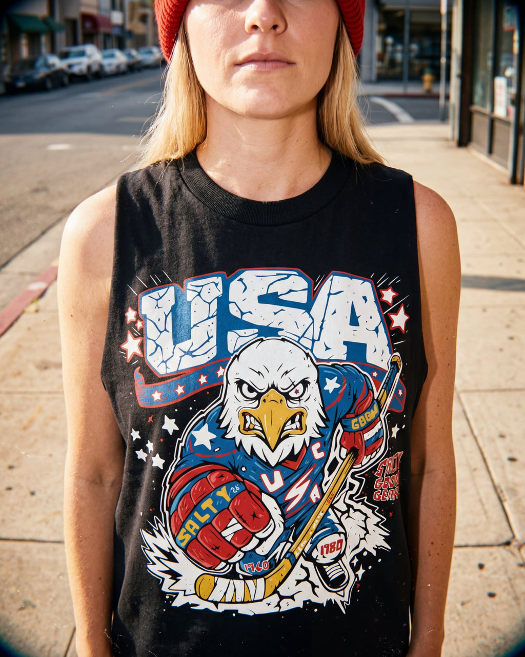 Person wearing a black tank top with a USA graphic design featuring an eagle.