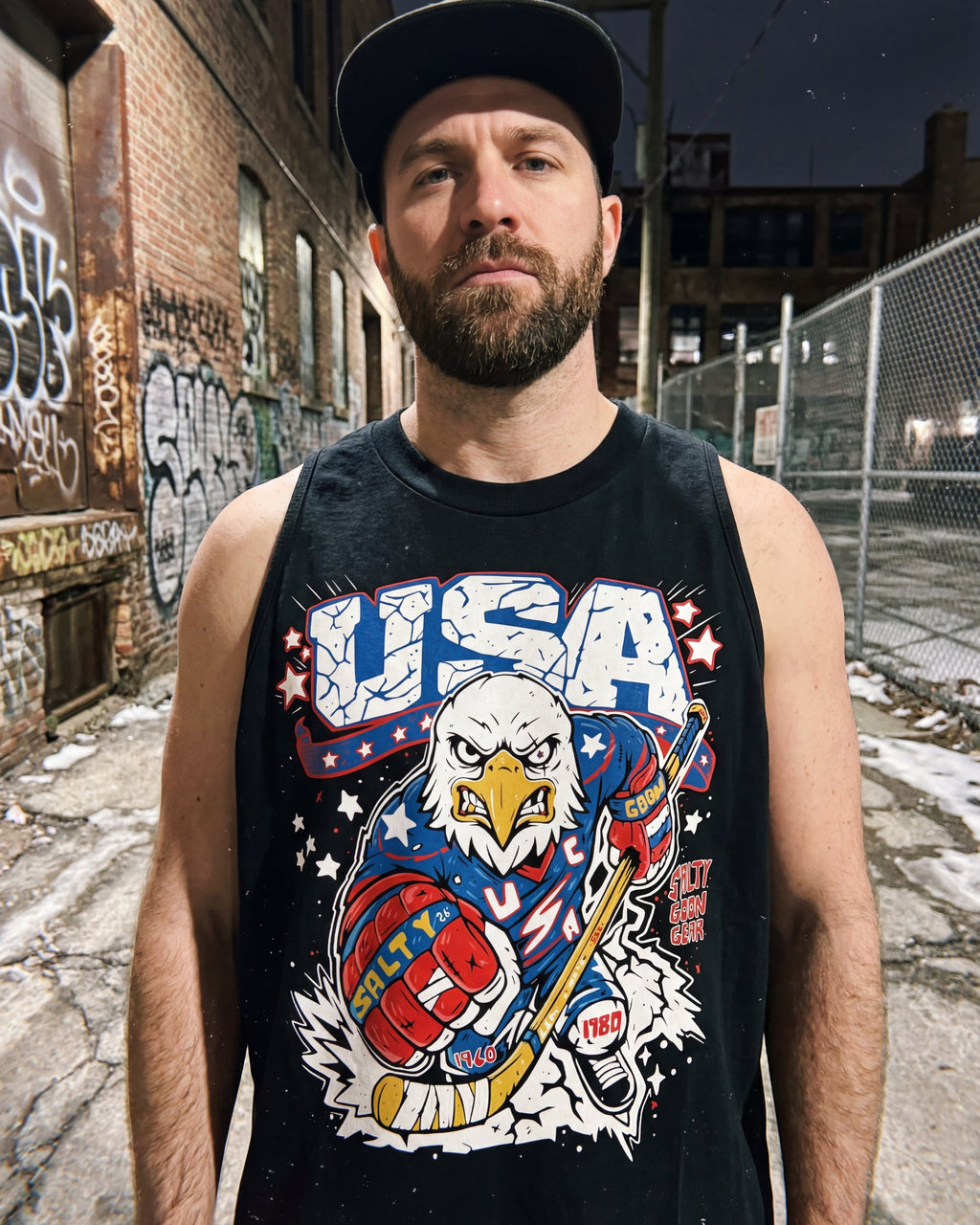 Man wearing a tank top with a USA-themed graphic in an urban setting