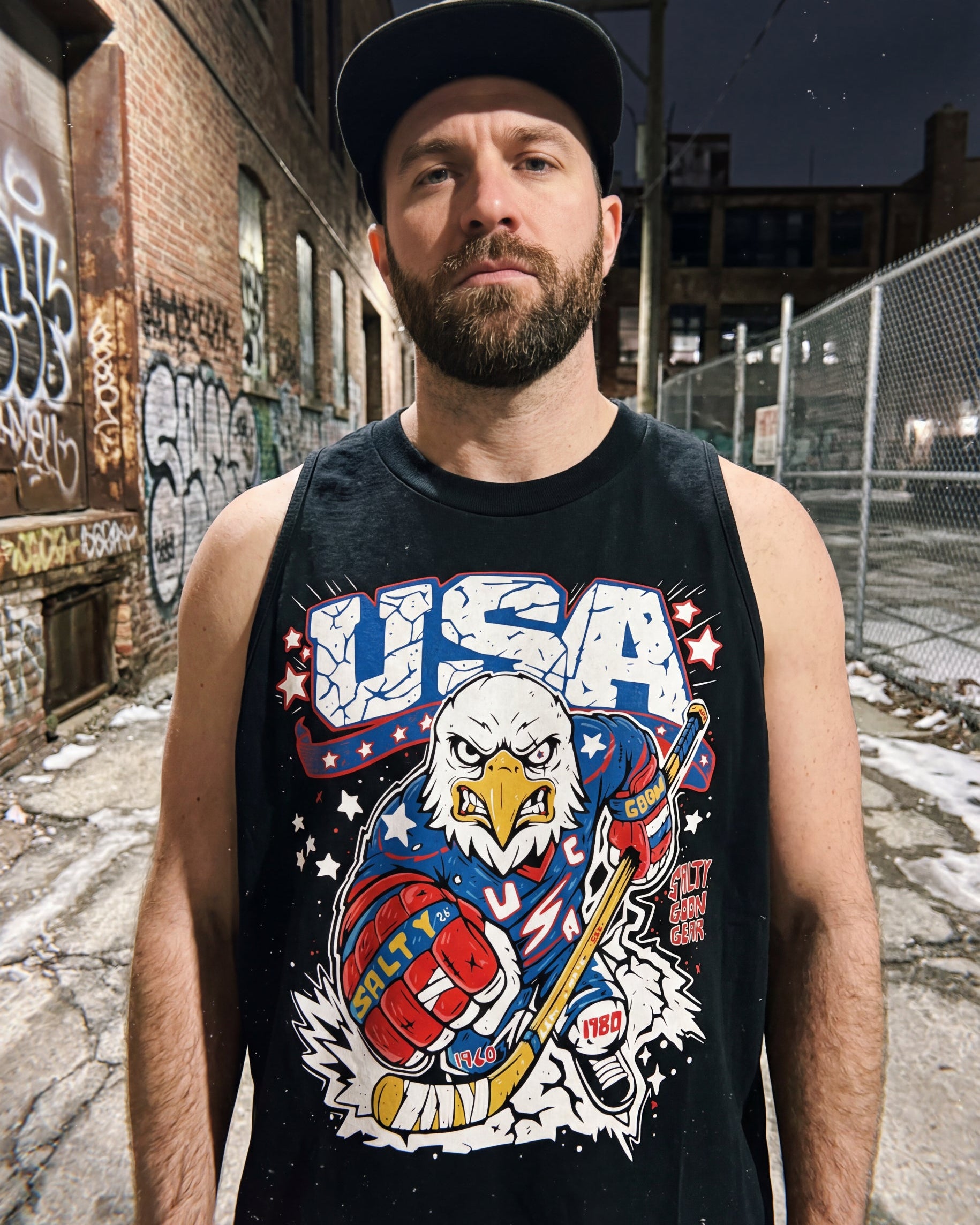 Man wearing a tank top with a USA-themed graphic in an urban setting